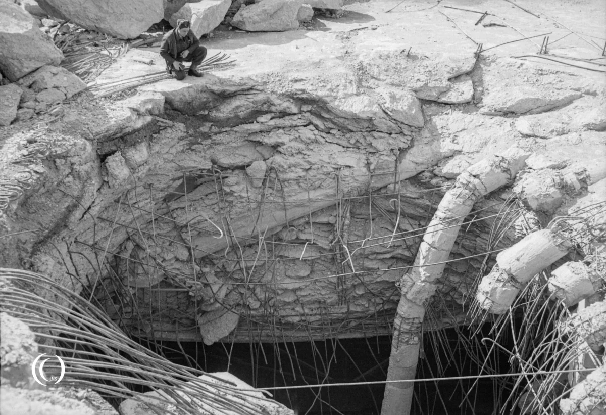 An RAF officer inspects the hole left by a 22,000-lb deep-penetration 'Grand Slam' bomb in the bunker roof of Valentin
