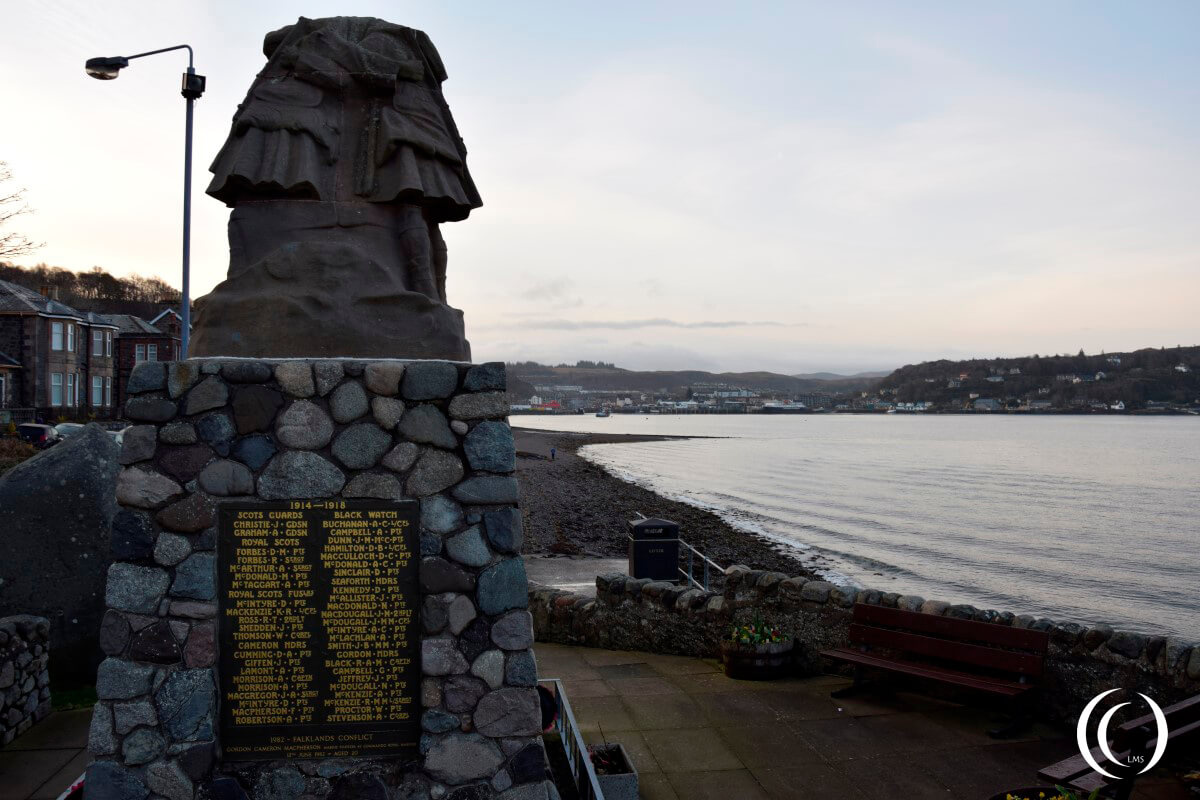 Oban war memorial Scotland, with the city of Oban in the back