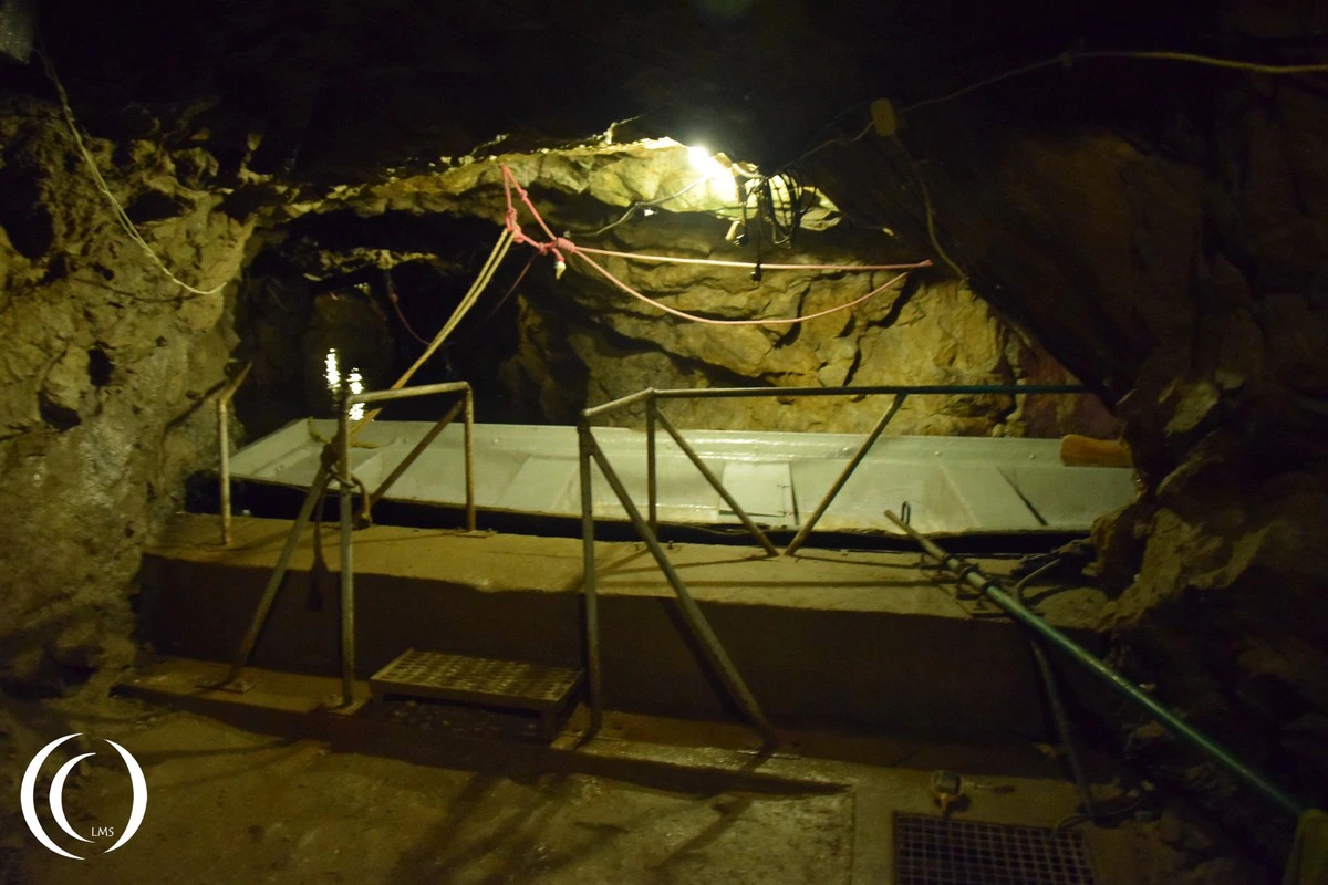 A boat taking visitors through the flooded tunnel system at Wlodarz, Poland