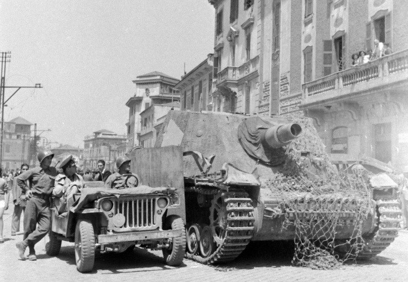 American Soldiers and a Willys MB Jeep next to a Sturmpanzer IV Brummbar- Courtesy Parkpatriot
