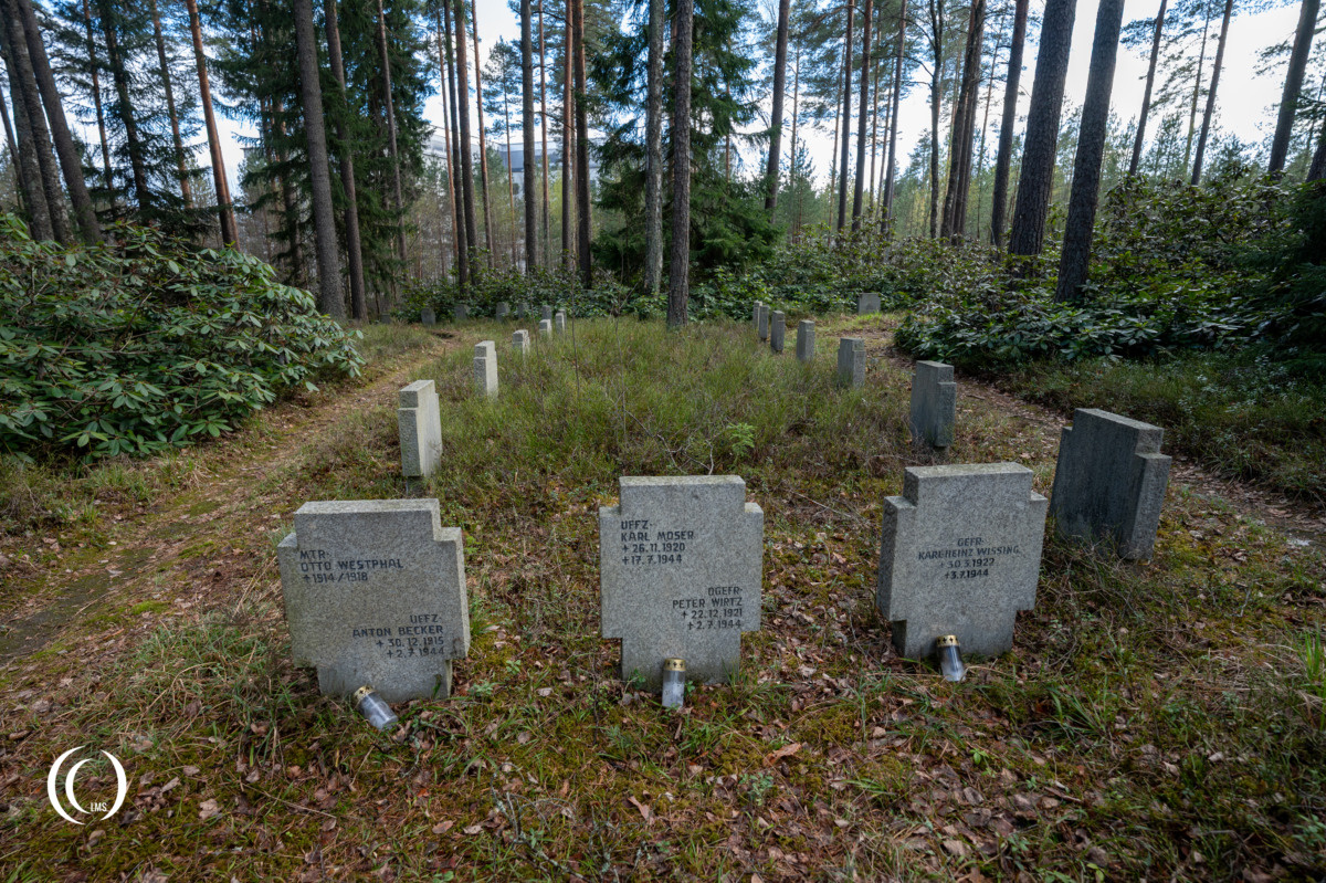 Headstones along a path at the German War Cemetery Helsinki-Honkanummi in Finland