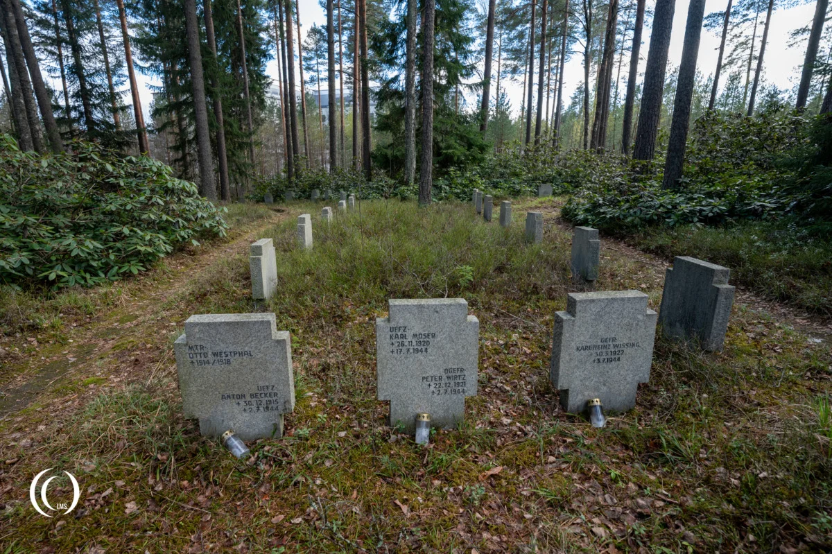 Headstones along a path at the German War Cemetery Helsinki-Honkanummi in Finland