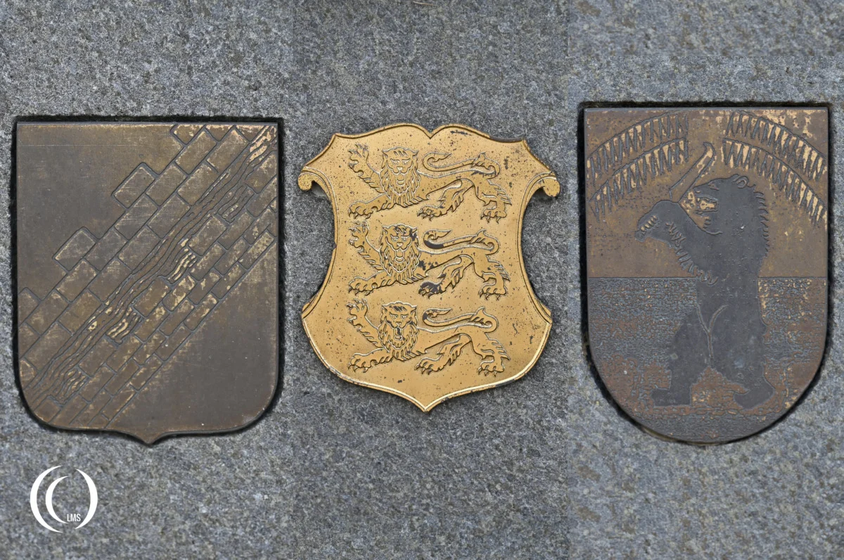 Three Coats of Arms on the Brothers-in-Arms Memorial at Hietaniemi Cemetery in Helsinki, Finland