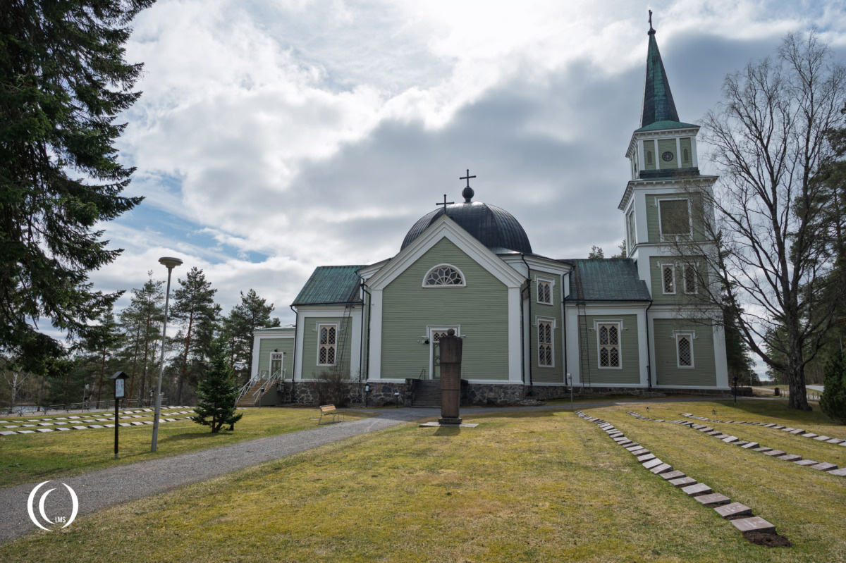 Ruokolahti Military Cemetery with the church in the background.