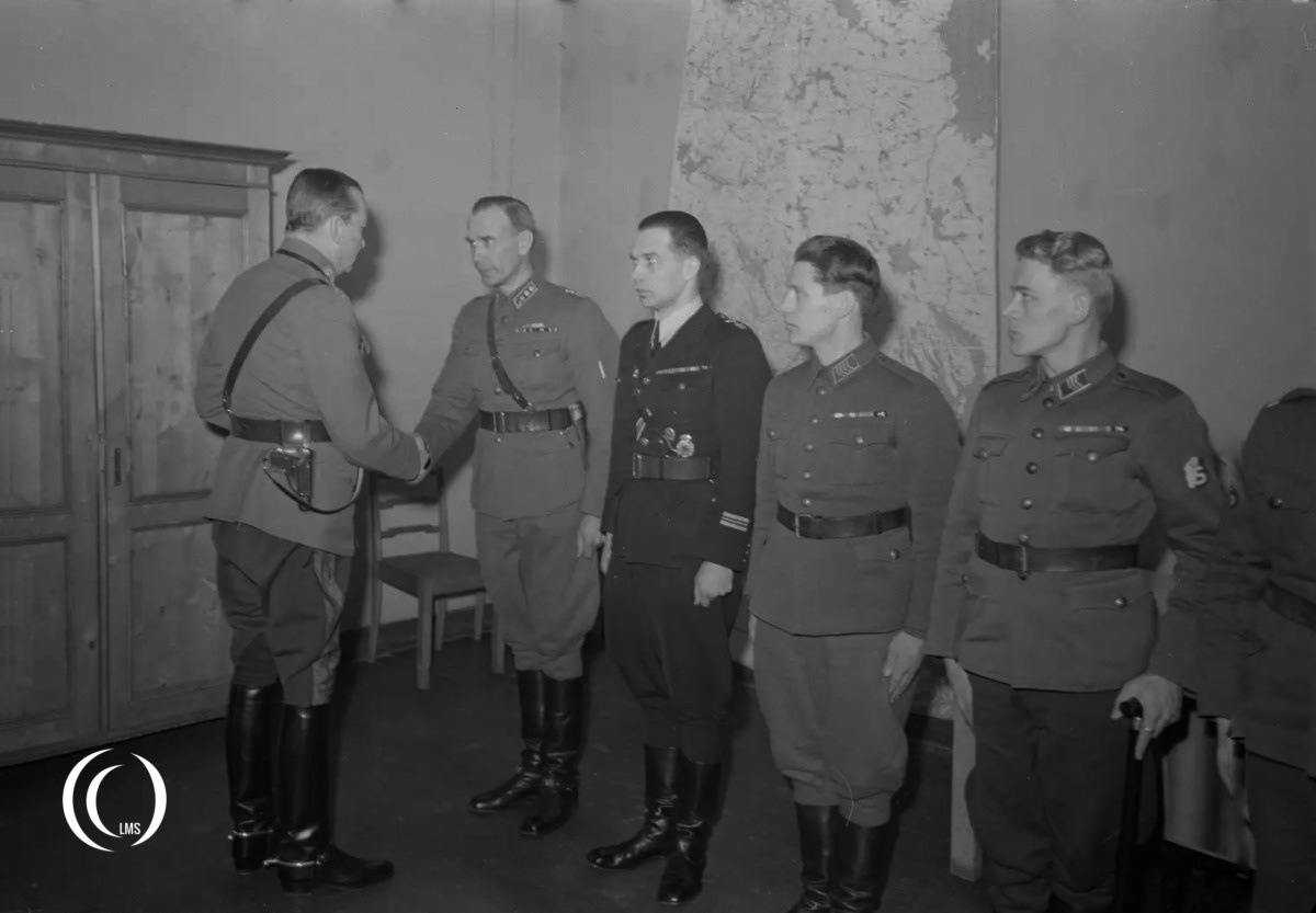 Marshal Carl Gustaf Mannerheim awarding Mannerheim Cross decorations in 1943